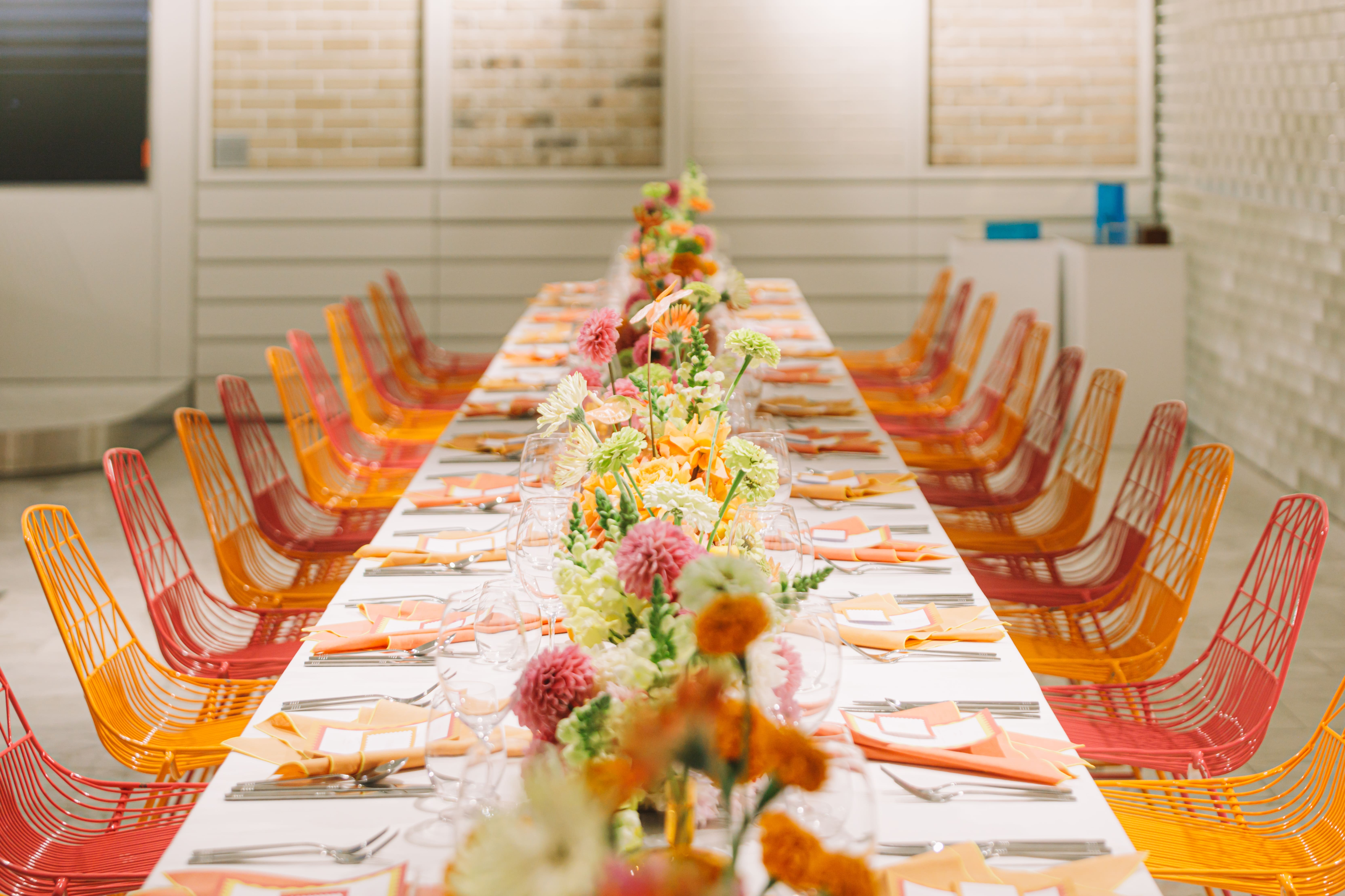 Long banquet table styled with colourful floral centrepieces by Stem Design for a luxury corporate event in Brisbane.