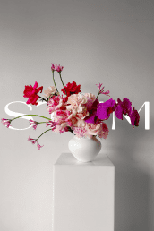 Weekly corporate flower delivery in Brisbane CBD with pink, purple, white, and red floral vase arrangement.