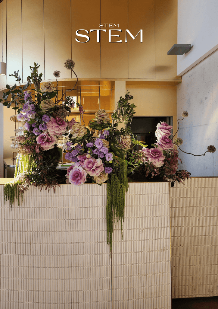 Large floral bar arrangement with green, purple and pink flowers by wedding florist Stem Design Brisbane.
