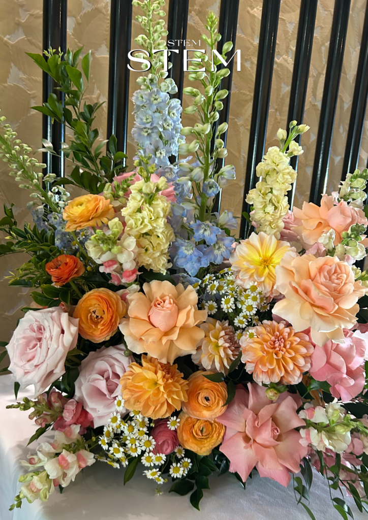 Elegant floral entrance arrangement featuring white delphiniums, amaranthus, and roses styled by Stem Design Brisbane.