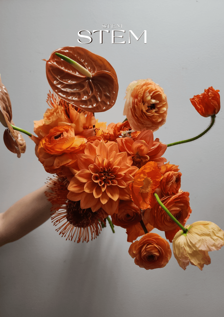 Unique flower bouquet featuring orange dahlias, ranunculus, poppies, and anthuriums styled by Stem Design Brisbane.
