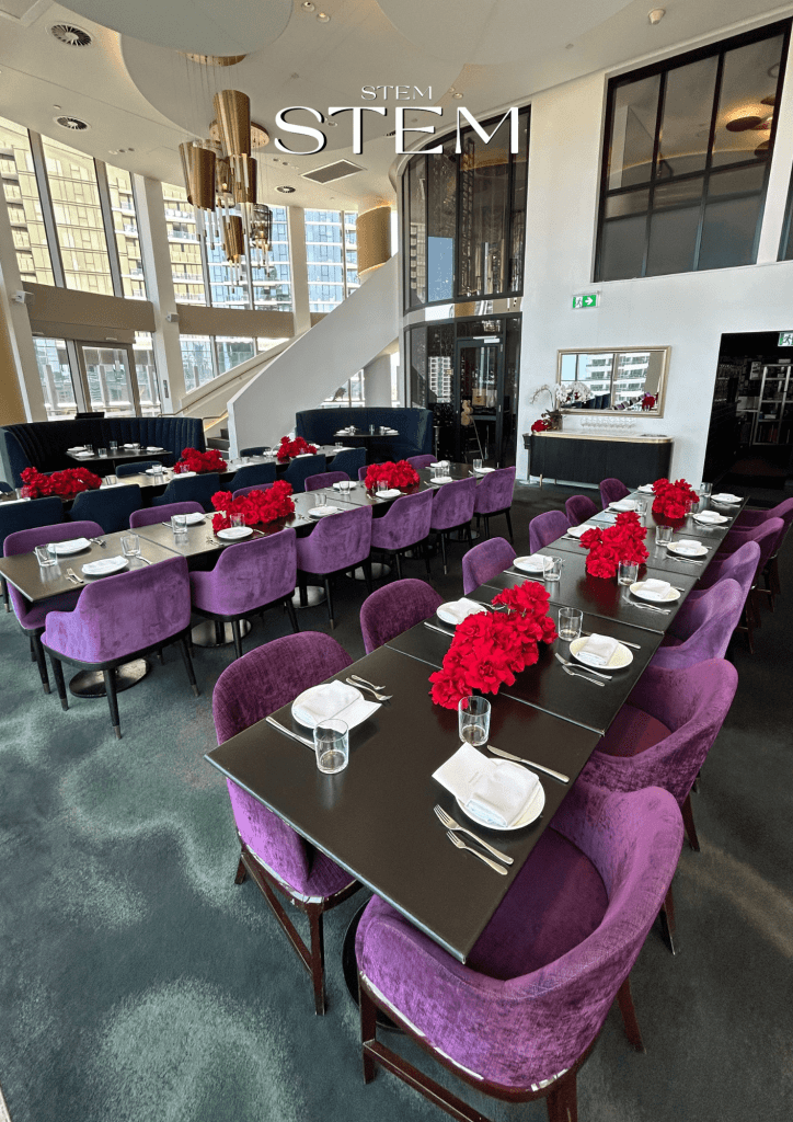 VIP dinner table styling with rich red rose arrangements at Nineteen at The Star, designed by Stem Design.