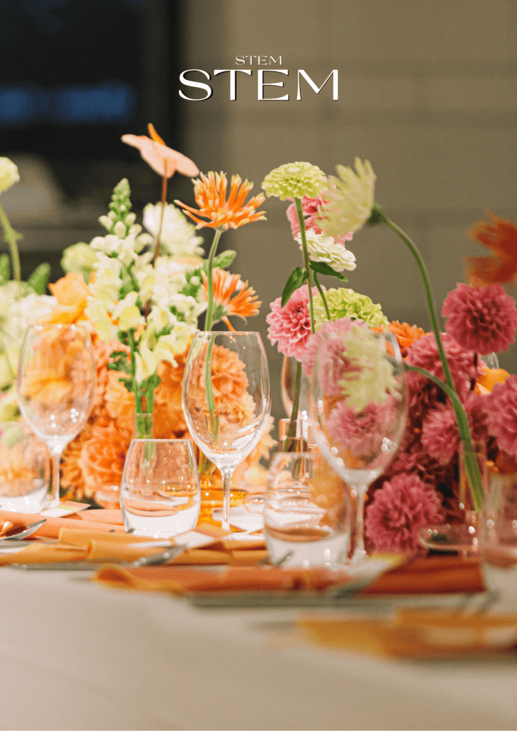 Colourful event table flowers arranged with bright pink, orange and green blooms for a Brisbane event.