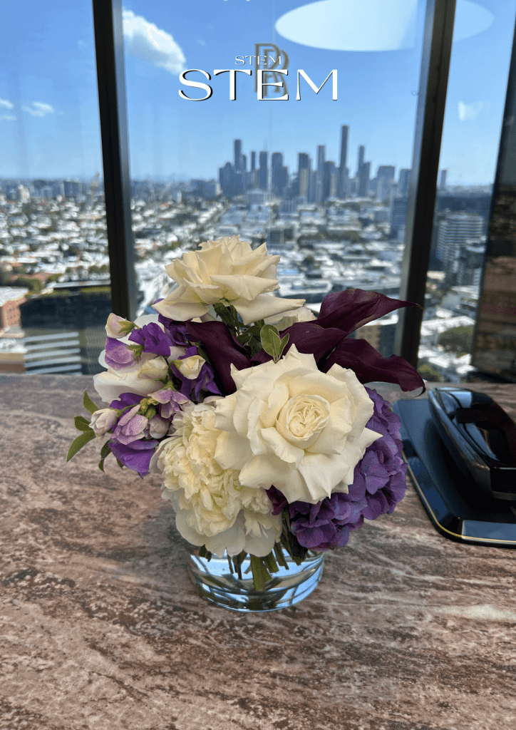 Event florist Gold Coast corporate table arrangement featuring white roses, hydrangea and deep purple calla lilies styled by Stem Design