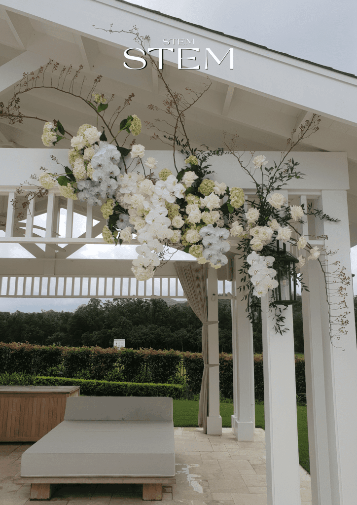 Unique wedding flower ideas 2026 featuring a cascading white orchid and rose installation by a wedding florist Brisbane.